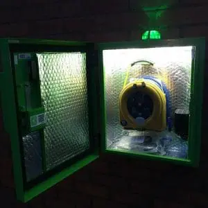 HeartSafe Cabinet with a defibrillator hanging on a hook